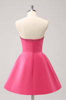 Laden Sie das Bild in den Galerie-Viewer, Glitzerndes A-Linie fuchsia trägerloses Abiballkleid mit Perlen und Schleifen